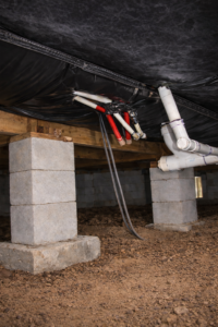 Properly installed vapor barrier under a Florida mobile home with sealed insulation and clean, dry crawl space