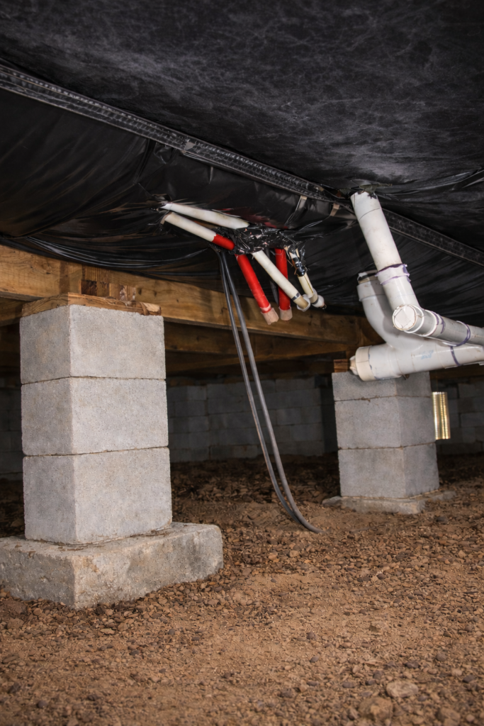 Properly installed vapor barrier under a Florida mobile home with sealed insulation and clean, dry crawl space