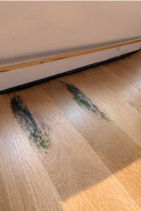 Mobile home flooring before repair showing damage and uneven surfaces